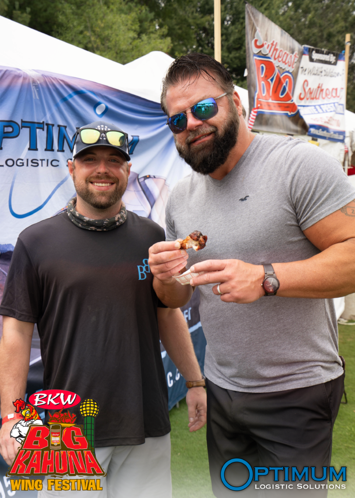 Chris and Rick enjoying wings at the Optimum Logistic Solutions OLS booth at the Big Kahuna Wing Festival 2022